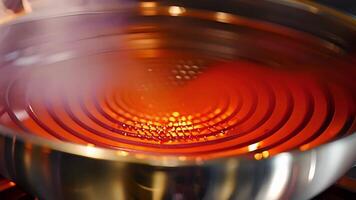 A detailed capture of the inner heating element in an electric wok showing its durable and highquality construction. This element provides consistent and powerful heat for cooking al video