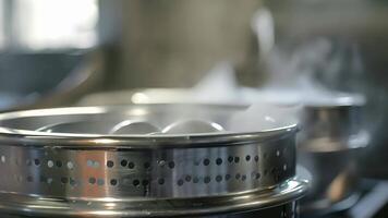The steam vents on the side of a multitiered steamer allowing for even distribution of steam for efficient cooking video