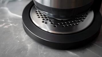 A closeup of the blenders metal base featuring a nonslip rubberized bottom and ventilation holes for efficient cooling during use video
