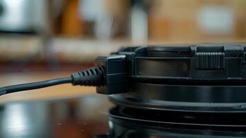 A closeup of the electric plug and cord highlighting its location on the back of the crepe maker and its ability to be easily unplugged for storage or cleaning video