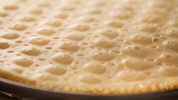 Closeup of the gridded surface of the crepe maker featuring small indentations to ensure the batter spreads evenly for perfectly round crepes video