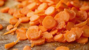 Thin slices of crunchy carrots sit neatly on the chopping board having just been diced by the powerful electric chopper video