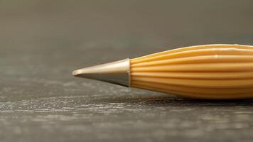 A closeup of a pastry tip with a classic ribbed design offering the perfect grip for creating intricate designs and patterns video