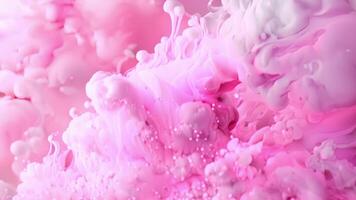 A pale pink ink with delicate swirls of white suspended within reminiscent of a galaxy captured in a small vial video