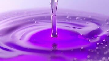 A soft lavender ink captured in a round droplet suspended on the edge of its container highlighting its unique hue video