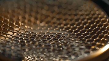 A closeup of a microphones pop filter reveals its intricate mesh construction designed to reduce popping and background noise while streaming video