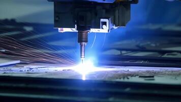 A plasma ter creates sparks as it s through thick sheets of metal for a satellites framework.. video