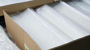 The satisfying sound of paper being neatly stacked and packaged for shipping.. video