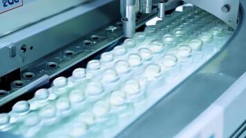 A machine precisely s and shapes gel capsules before they are filled with medication and sealed.. video