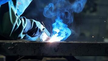 A closeup of a welding machine in action with the intense heat visibly melting the metal.. video