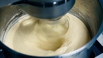 A closeup of an industrial mixer emulsifying different ingredients to create a specialized lubricant formula.. video