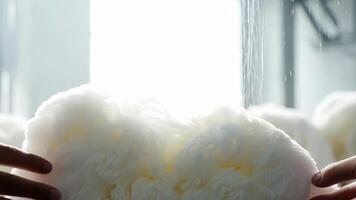A cloud of cotton being pulled into shape ready for the next stage of production.. video