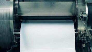 The rhythmic movement of the paper feeder as it systematically transports paper through the press for printing.. video