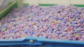 The vibrant array of colors seen in the raw plastic pellets waiting to be transformed into a molded product.. video