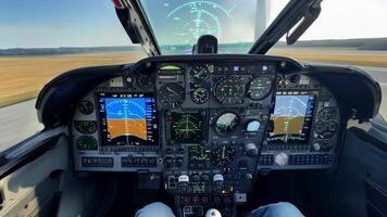 A pilot in a cockpit preparing for takeoff, surrounded by advanced avionics and controls. video