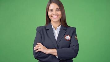 A woman in gray work clothes with yellow patch on the back She smiles and looks at the camera. video