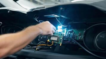 A technician installing advanced electronics in a vehicle dashboard. video
