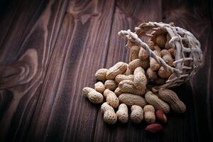 Peanuts in shell on wooden background photo