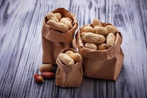 Peanuts in shell on wooden background photo