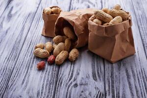 Peanuts in shell on wooden background photo