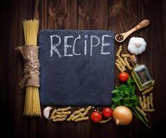 Tomato, uncooked pasta, garlic, parsley photo
