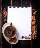 Coffee, sugar, cinnamon, cookies and open notebook photo