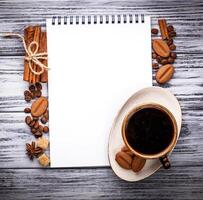 Coffee, sugar, cinnamon, cookies and open notebook photo
