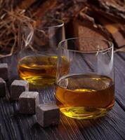 Glass of whiskey with stones photo