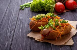 Hot dog with sausage, carrot, onion, lettuce photo