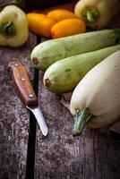 Fresh zucchini on wooden background photo