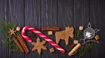 Christmas background with cookies, tree and cinnamon photo