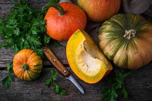 Autumn still life with pumpkins on wooden background photo