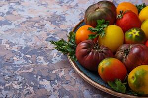 Different sort of tomato on concrete background photo