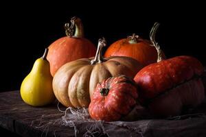 Pumpkins on wooden table in dark background photo