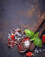 Wooden spoon with salt and pepper. photo