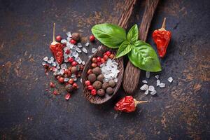 Wooden spoon with salt and pepper. photo