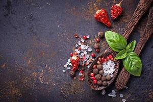 Wooden spoon with salt and pepper. photo