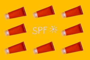 Sunscreen SPF cream pattern on yellow background photo