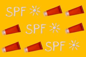 Sunscreen SPF sunblock cream on yellow background photo