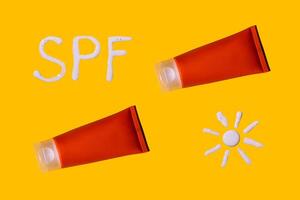 Sunscreen SPF sunblock cream on yellow background photo