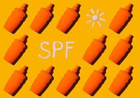 Sunscreen SPF sunblock cream on yellow background photo