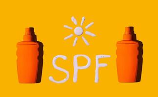 Sunscreen SPF sunblock cream on yellow background photo