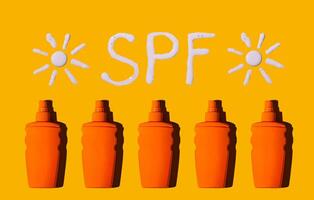 Sunscreen SPF sunblock cream on yellow background photo