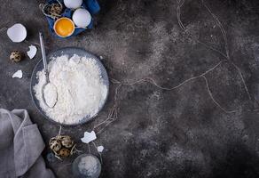 Baking ingredients with flour and eggs photo