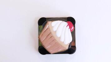 Gingerbread in the form of a cupcake spins on a plastic tray. An example of a confectioner work. View from above. video