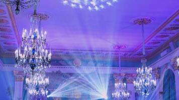 Powerful moving light beams on the ceiling structure in the interior of a public event, fashion show, concert or wedding reception video