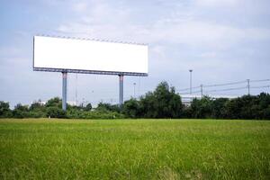 blank billboard on the sideway in the park. image for copy space, advertisement, text and object. white billboard in natural green. photo