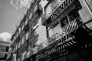View of the facade of a black and white building with balconies. City. The steel facade of a residential building in the city. photo