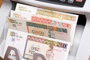 Cuban Convertible Pesos in the counting machine photo