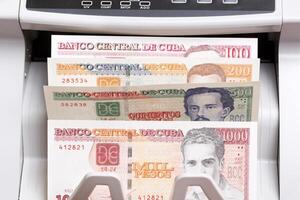 Cuban Peso in the counting machine photo